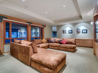 This luxurious family room boasts a spacious sectional sofa, perfect for movie nights and family gatherings.