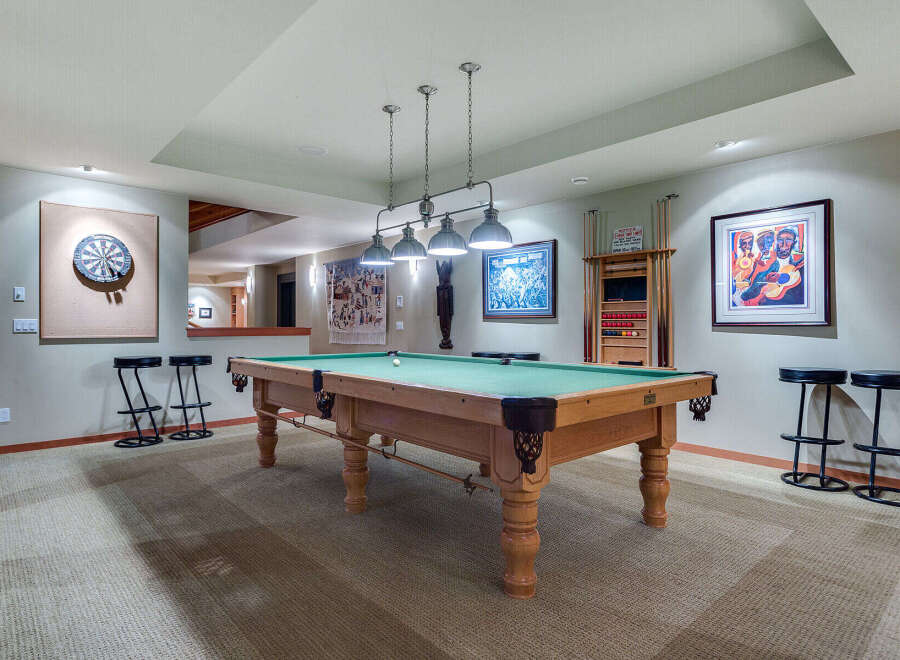 This stunning game room boasts a regulation-size pool table, perfect for friendly competitions.