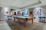 This stunning game room boasts a regulation-size pool table, perfect for friendly competitions.