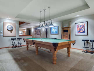 This stunning game room boasts a regulation-size pool table, perfect for friendly competitions.
