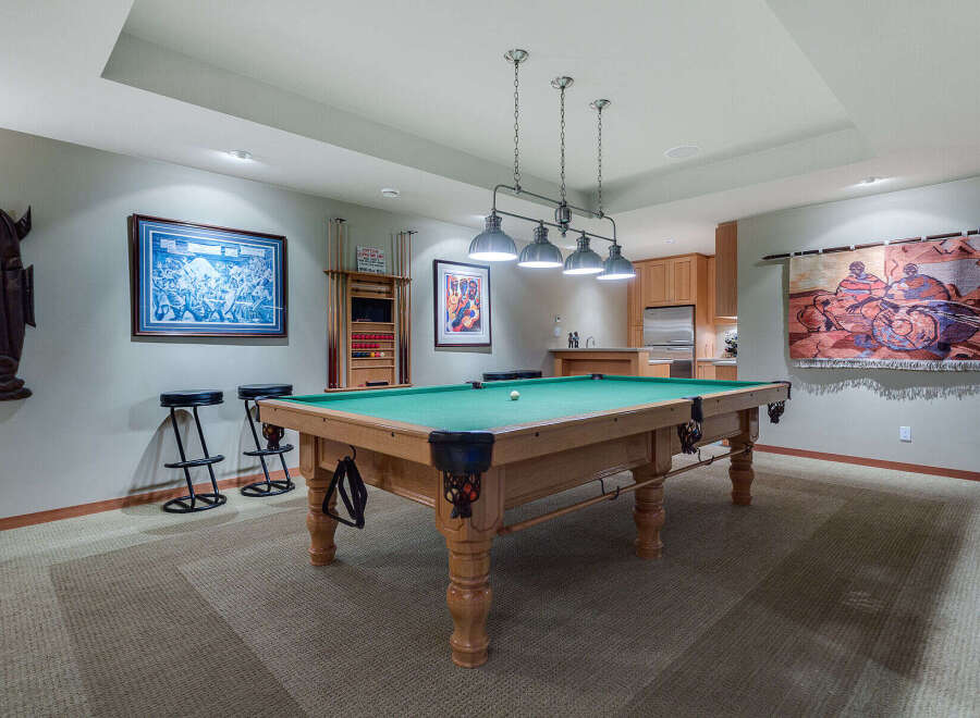 This stunning game room boasts a regulation-size pool table, perfect for friendly competitions.