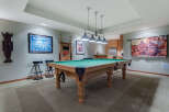 This stunning game room boasts a regulation-size pool table, perfect for friendly competitions.