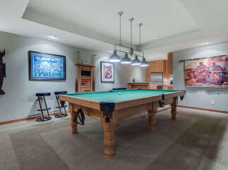 This stunning game room boasts a regulation-size pool table, perfect for friendly competitions.