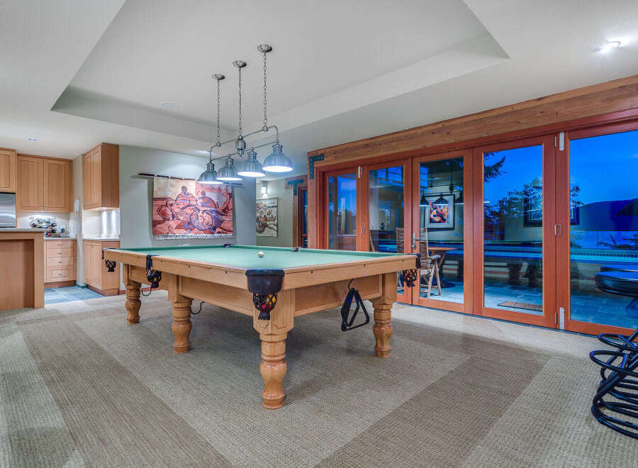 This stunning game room boasts a beautiful pool table, perfect for friendly competitions.