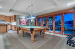 This stunning game room boasts a beautiful pool table, perfect for friendly competitions.