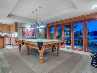 This stunning game room boasts a beautiful pool table, perfect for friendly competitions.