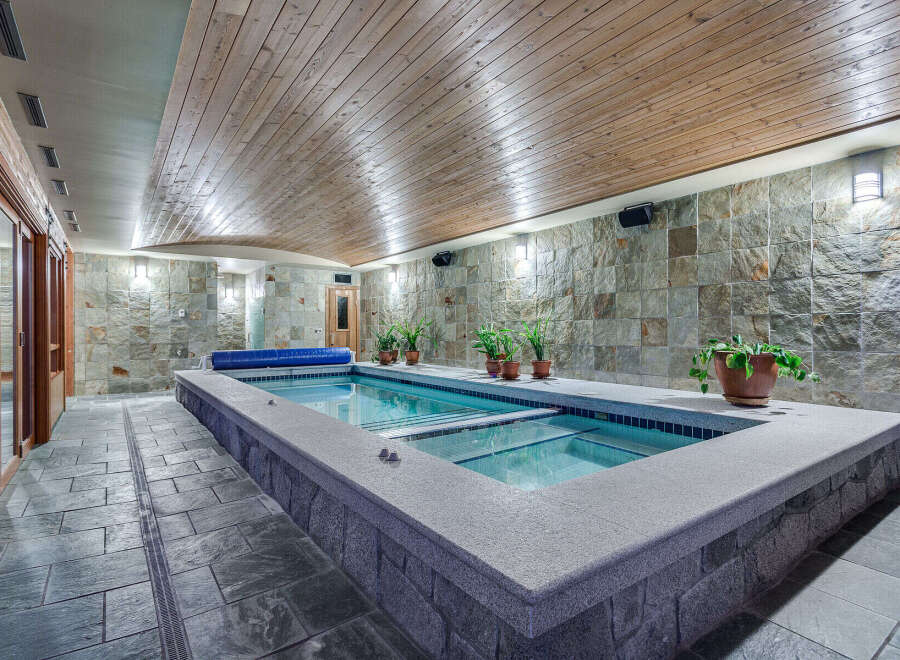 Indulge in this luxurious indoor lap pool, featuring a sleek design and tranquil ambiance.