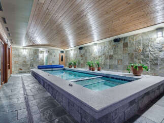 Indulge in this luxurious indoor lap pool, featuring a sleek design and tranquil ambiance.
