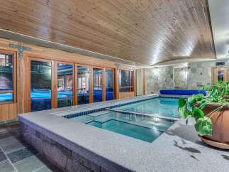Indulge in the ultimate relaxation experience with this stunning indoor pool and hot tub.