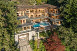 This stunning waterfront property boasts a multi-level home with expansive windows offering breathtaking views, a private infinity pool and hot tub, and a boat lift for convenient water access.