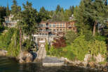 This stunning waterfront property boasts a multi-level home with expansive windows offering breathtaking views, a private boat lift for convenient water access, and lush landscaping creating a secluded oasis.