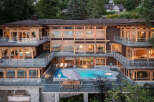 This stunning multi-level home boasts breathtaking waterfront views, expansive decks with glass railings, and a luxurious outdoor oasis complete with a swimming pool and hot tub.