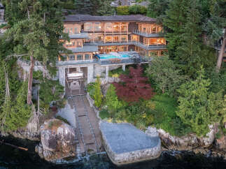 This stunning waterfront property boasts a multi-level home with expansive windows offering breathtaking views, a private infinity pool, and a convenient boat lift for effortless water access.