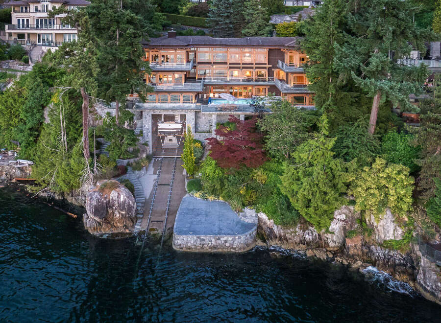 This stunning waterfront property boasts a multi-level home with expansive windows offering breathtaking water views, a private boat lift for convenient access to the ocean, and lush landscaping that enhances the natural beauty of the surroundings.