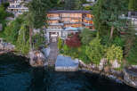 This stunning waterfront property boasts a multi-level home with expansive windows offering breathtaking water views, a private boat lift for convenient access to the ocean, and lush landscaping that enhances the natural beauty of the surroundings.