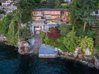 This stunning waterfront property boasts a multi-level home with expansive windows offering breathtaking water views, a private boat lift for convenient access to the ocean, and lush landscaping that enhances the natural beauty of the surroundings.