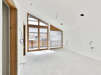 This stunning property boasts a spacious, open-plan design with large windows that flood the room with natural light.