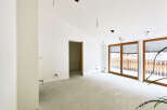 This spacious room boasts large windows offering ample natural light and views.