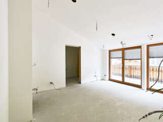 This spacious room boasts large windows offering ample natural light and views.