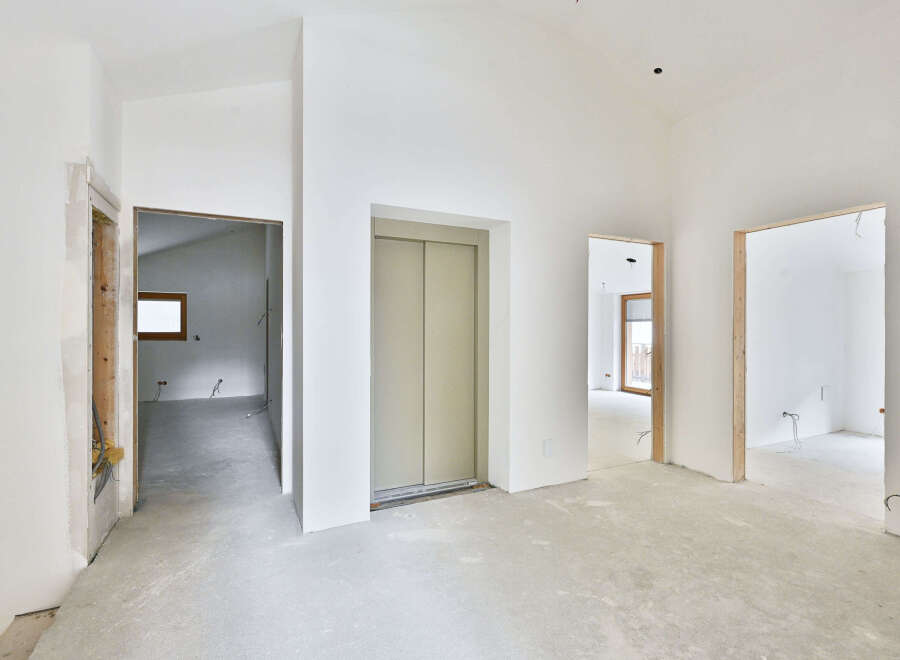 This stunning property boasts an open-concept design with high ceilings and sleek elevator access.