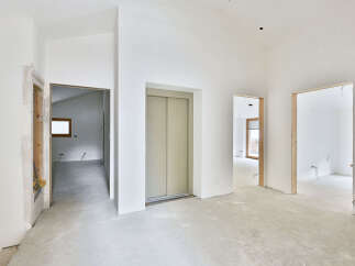 This stunning property boasts an open-concept design with high ceilings and sleek elevator access.