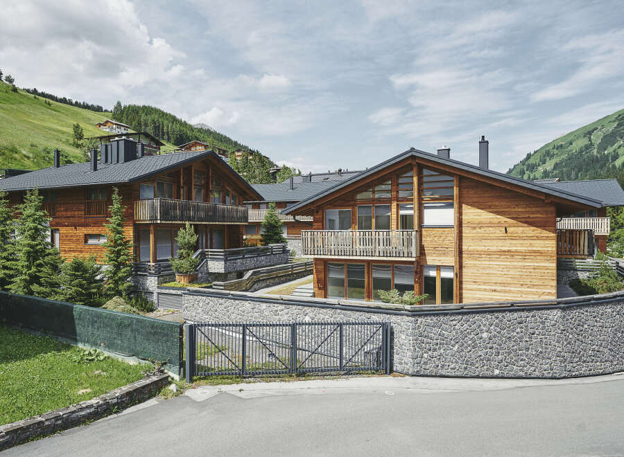 Luxury chalet-style homes nestled in a scenic mountainside setting.