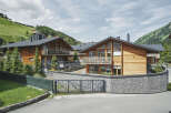 Luxury chalet-style homes nestled in a scenic mountainside setting.