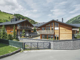 Luxury chalet-style homes nestled in a scenic mountainside setting.