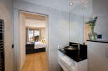 This luxurious bathroom boasts a modern design with sleek black fixtures and a spacious vanity, offering ample storage.