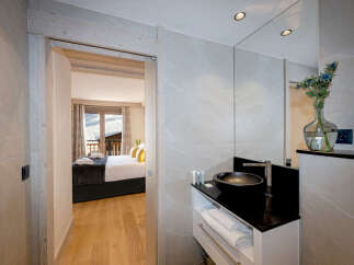 This luxurious bathroom boasts a modern design with sleek black fixtures and a spacious vanity, offering ample storage.
