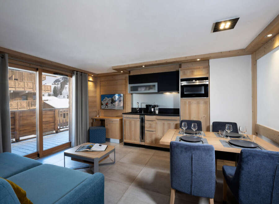 This stunning apartment boasts a spacious open-plan living area with a comfortable sofa and a modern kitchen equipped with all the necessary appliances.