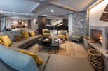 This luxurious living space boasts a spacious L-shaped sofa, perfect for relaxing by the cozy fireplace.
