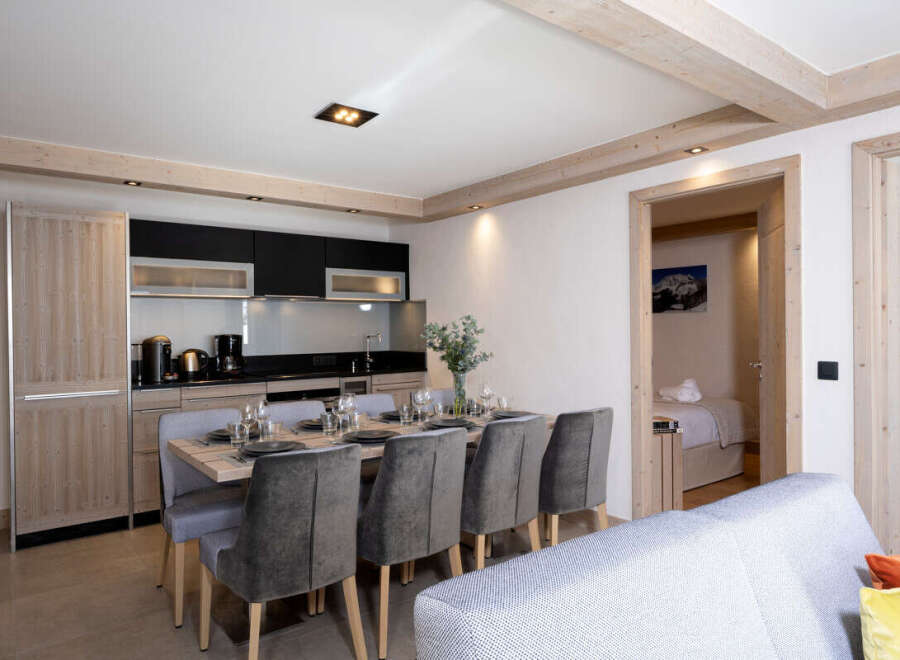 This stunning apartment boasts a spacious open-plan living area with a fully equipped kitchen, perfect for entertaining guests.
