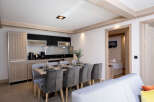 This stunning apartment boasts a spacious open-plan living area with a fully equipped kitchen, perfect for entertaining guests.