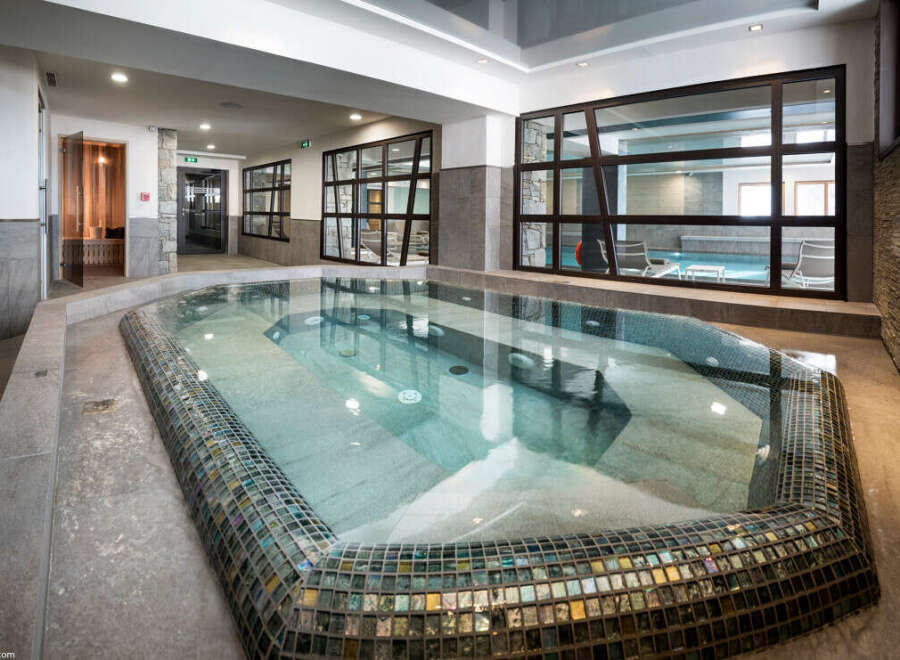 This luxurious spa boasts a stunning indoor hot tub, perfect for relaxation and rejuvenation.