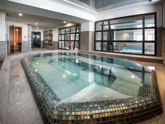 This luxurious spa boasts a stunning indoor hot tub, perfect for relaxation and rejuvenation.