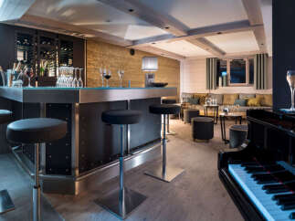This luxurious chalet boasts a stylish bar area complete with a sleek metal countertop, comfortable bar stools, and a sophisticated wine rack.