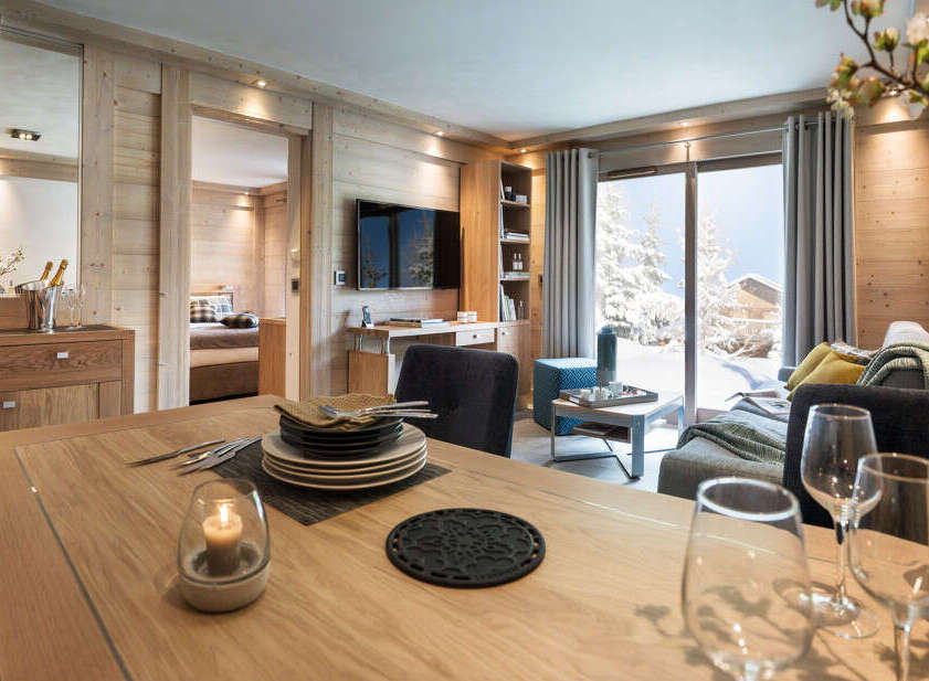 This stunning apartment boasts a spacious open-plan living area with floor-to-ceiling windows offering breathtaking mountain views.