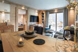 This stunning apartment boasts a spacious open-plan living area with floor-to-ceiling windows offering breathtaking mountain views.
