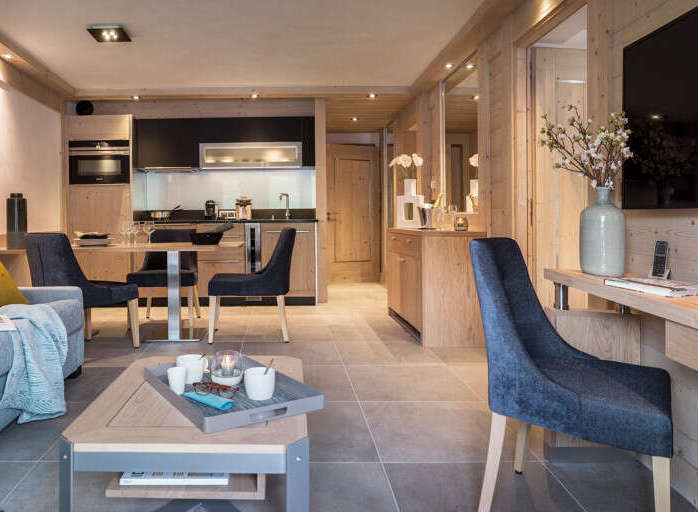 This stunning apartment boasts a spacious open-plan living area with a cozy sofa and a fully equipped kitchen.