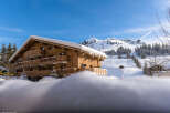 This stunning chalet boasts a prime location in a picturesque ski resort, offering breathtaking mountain views.