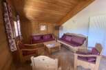 Cozy chalet living room with wooden furniture and tiled floor.