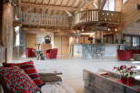 This stunning hotel lobby boasts a rustic-chic design with exposed wooden beams, a stone fireplace, and comfortable seating areas.