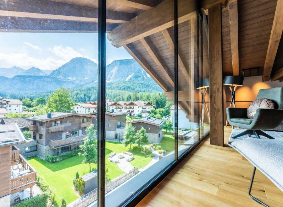 This luxurious chalet boasts breathtaking panoramic mountain views from its expansive windows, creating a serene and idyllic atmosphere.