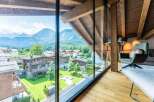 This luxurious chalet boasts breathtaking panoramic mountain views from its expansive windows, creating a serene and idyllic atmosphere.