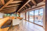 This luxurious penthouse boasts a stunning mountain view from its expansive terrace, accessible through large sliding glass doors.