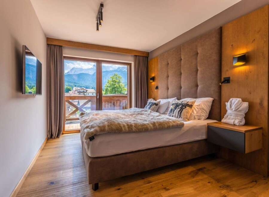 Wake up to breathtaking mountain views from this luxurious bedroom.