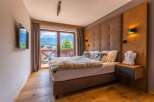 Wake up to breathtaking mountain views from this luxurious bedroom.