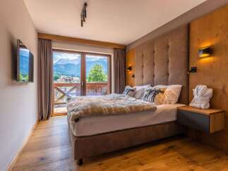 Wake up to breathtaking mountain views from this luxurious bedroom.