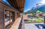 This stunning mountain chalet boasts a spacious balcony with breathtaking views, perfect for enjoying the fresh alpine air.